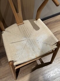 stained chair inside of the room.