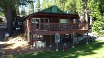 Ariel view of front of cabin. Two rooms downstairs with door.