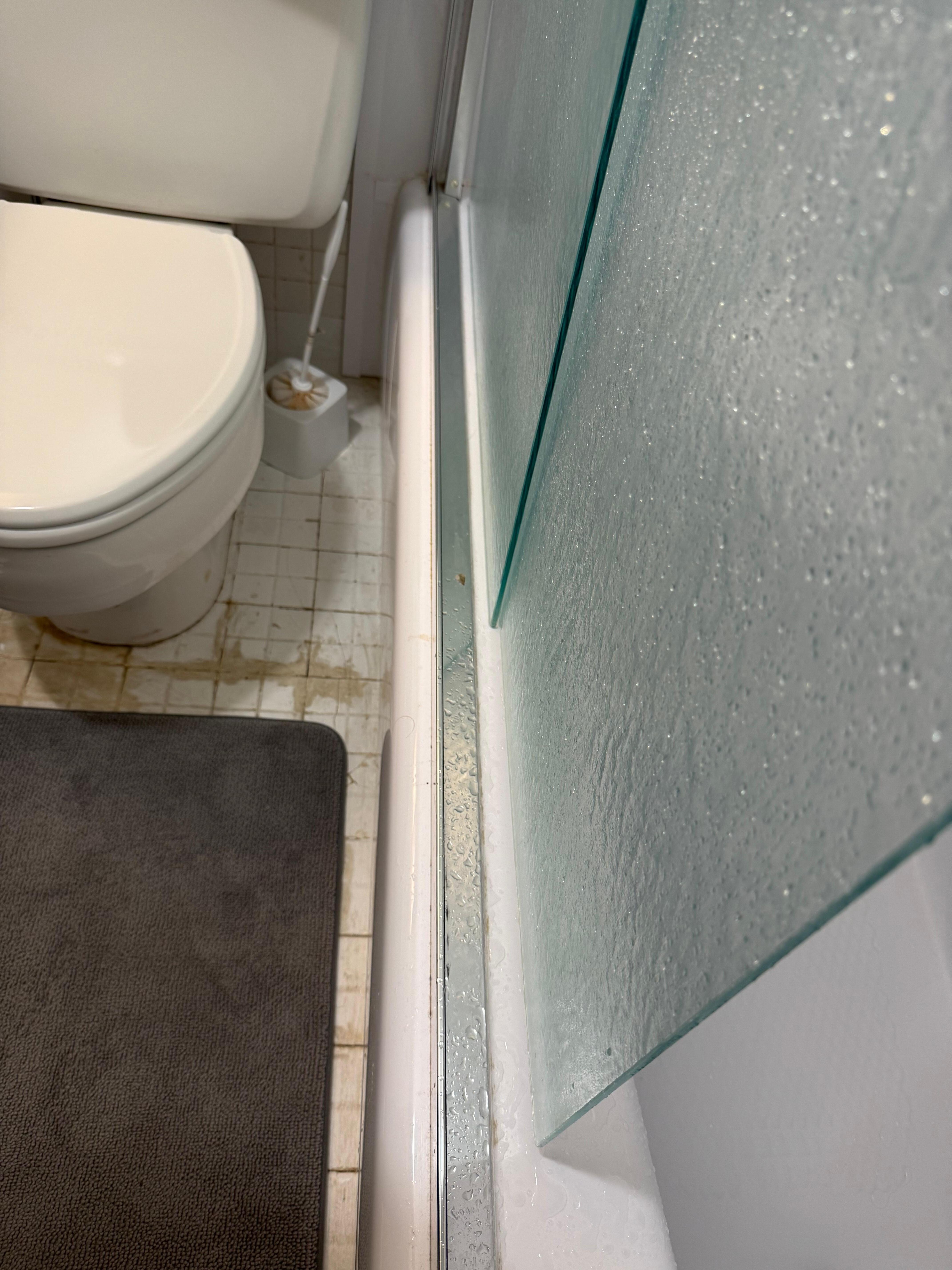 Allowing glass shower door not on track - slide with extreme caution