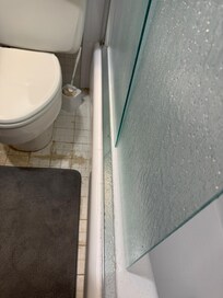 Allowing glass shower door not on track - slide with extreme caution