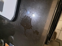 Sticky counter by coffee maker.