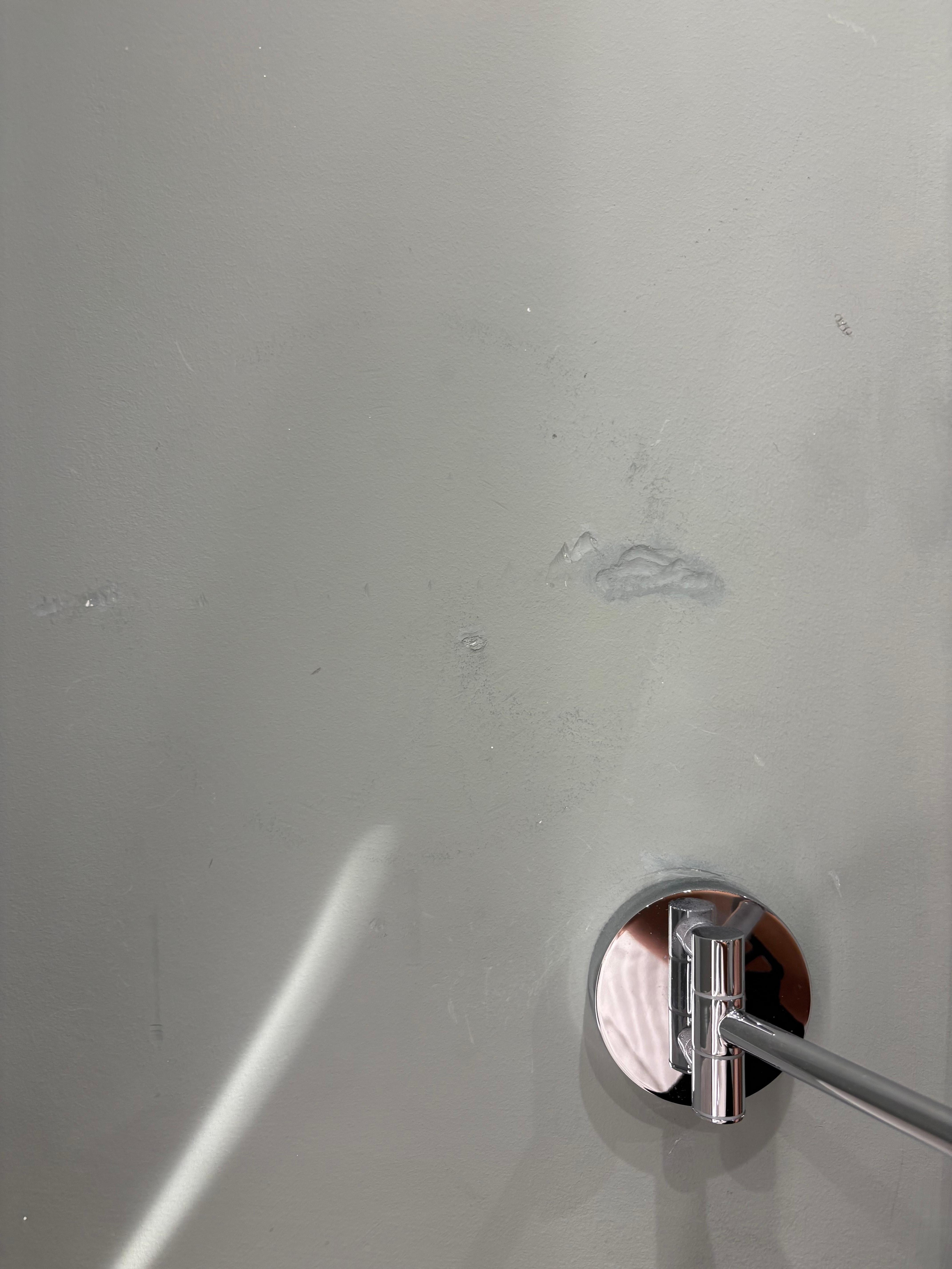 One of the many dents in the wall