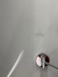 One of the many dents in the wall