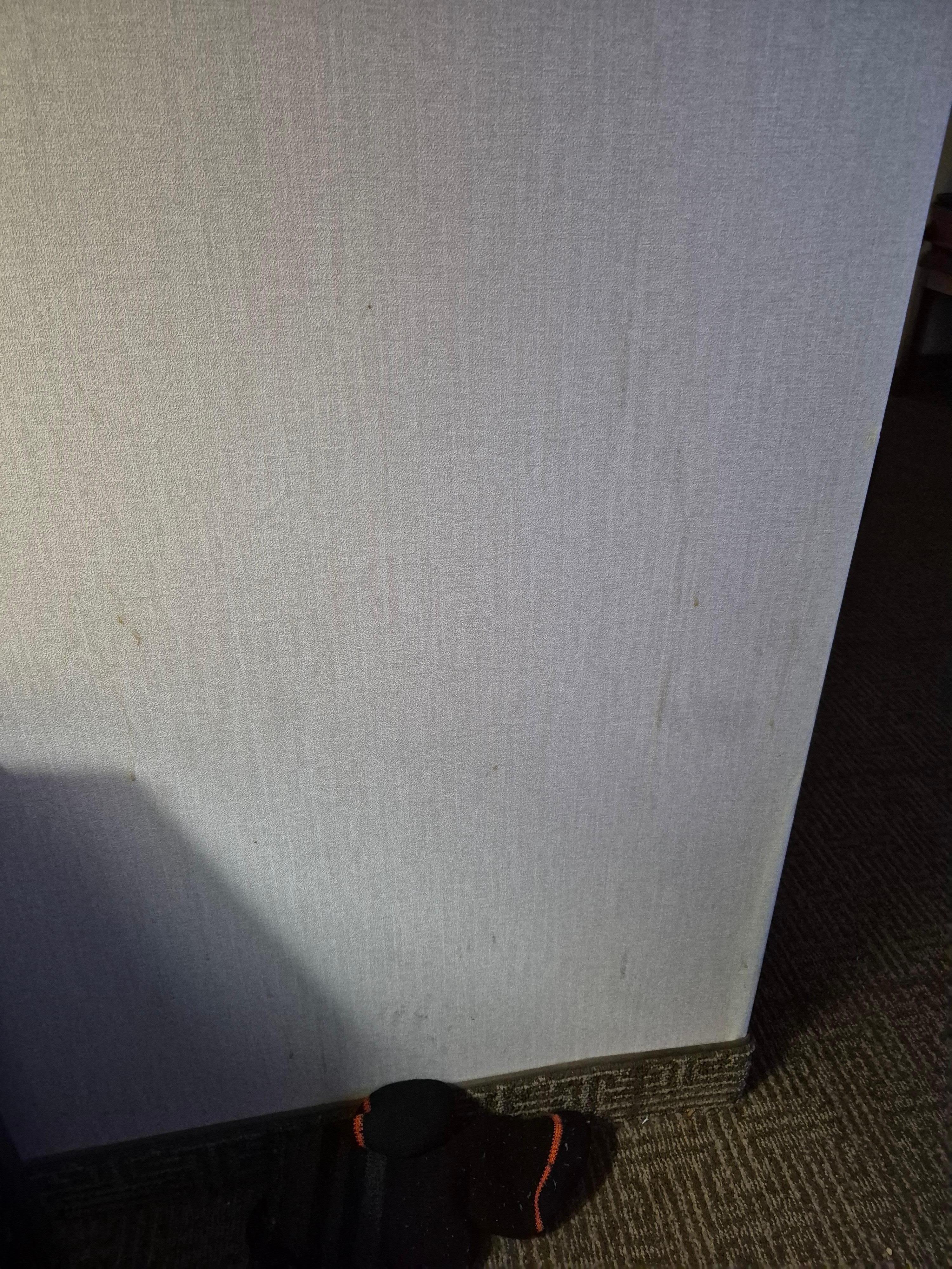 Wall by nightstand splattered