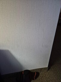 Wall by nightstand splattered