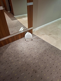 The heater is plugged down on the floor like a prisoner