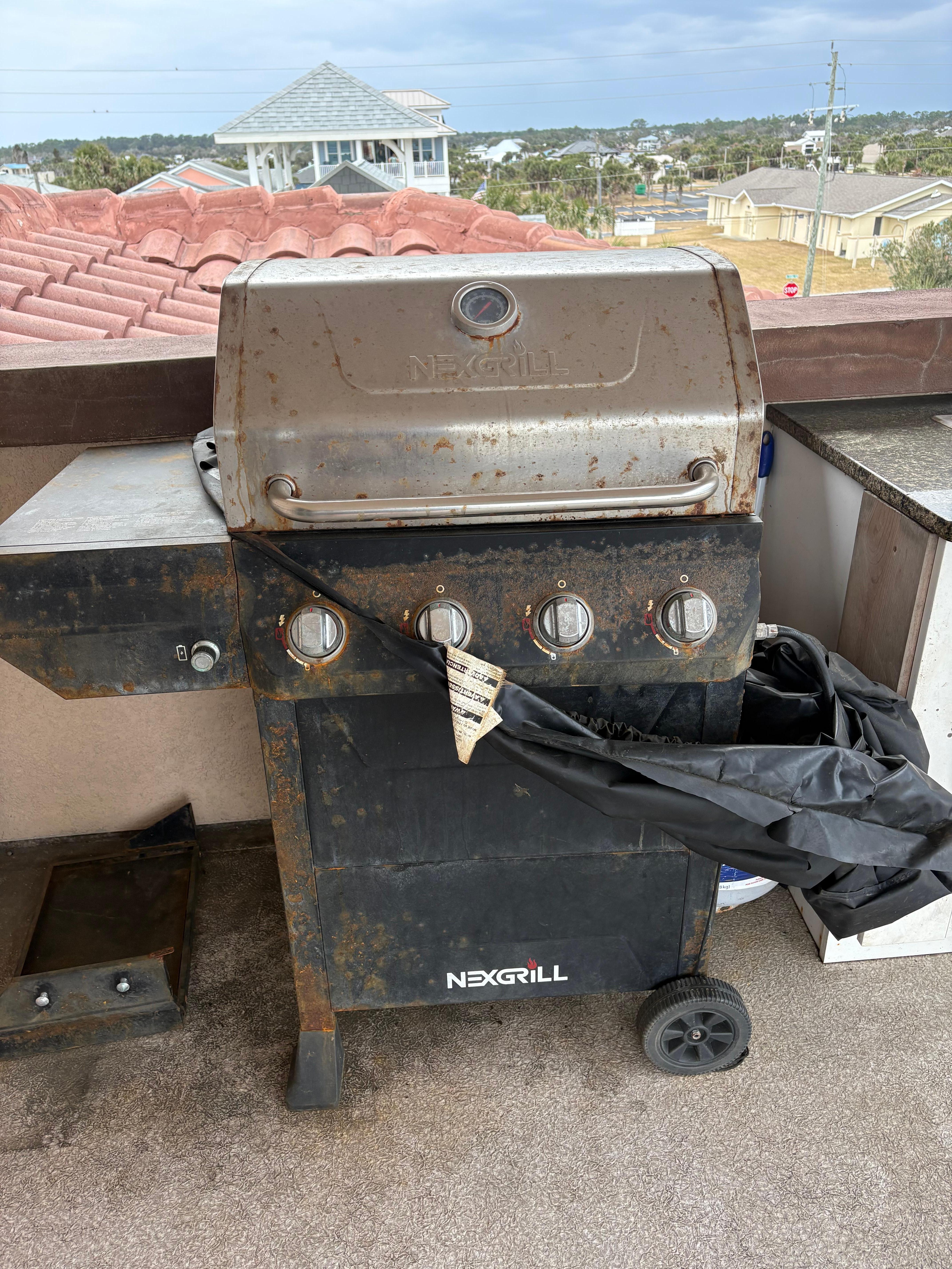 Rusty grill with torn cover