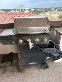 Rusty grill with torn cover