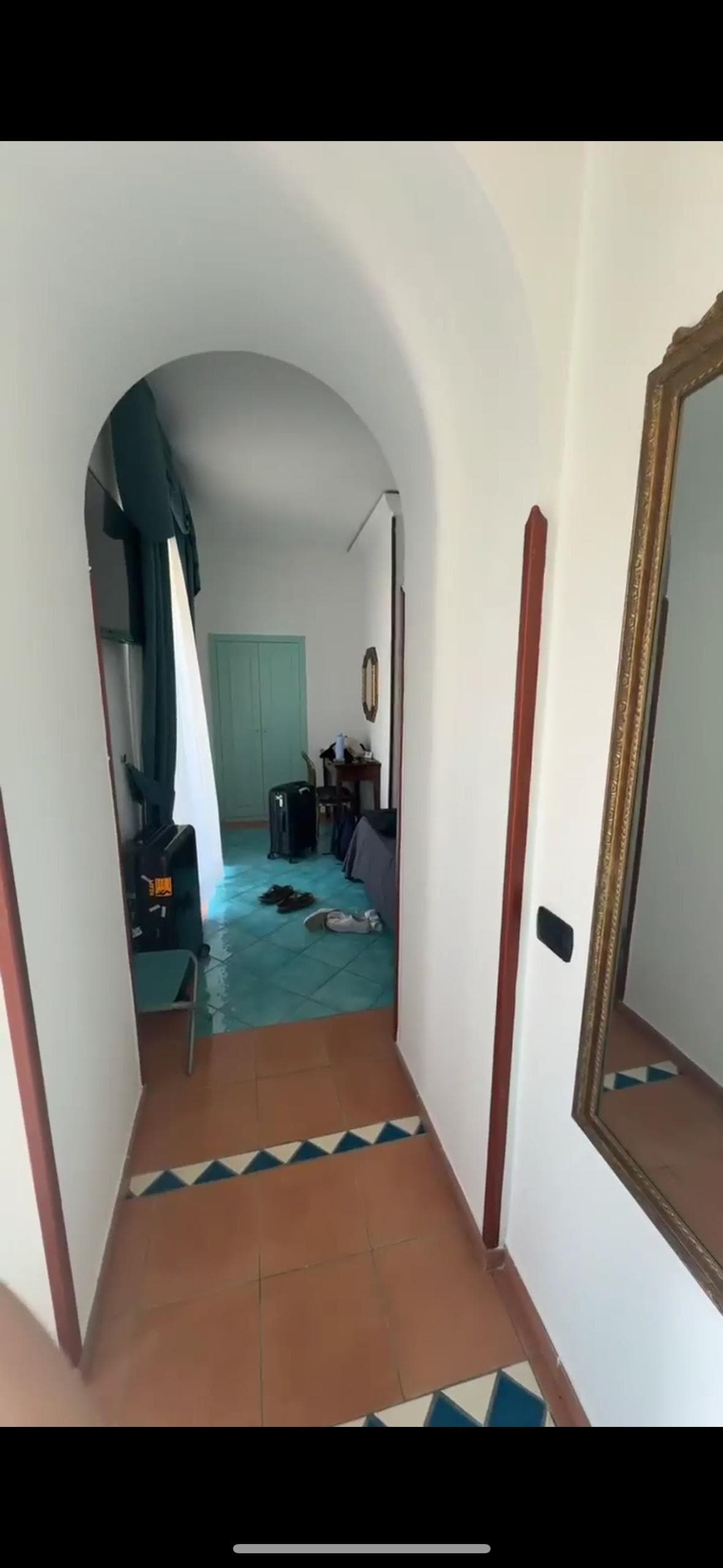 Room entrance way. To the left, balcony. To the right was small bathroom and bed.