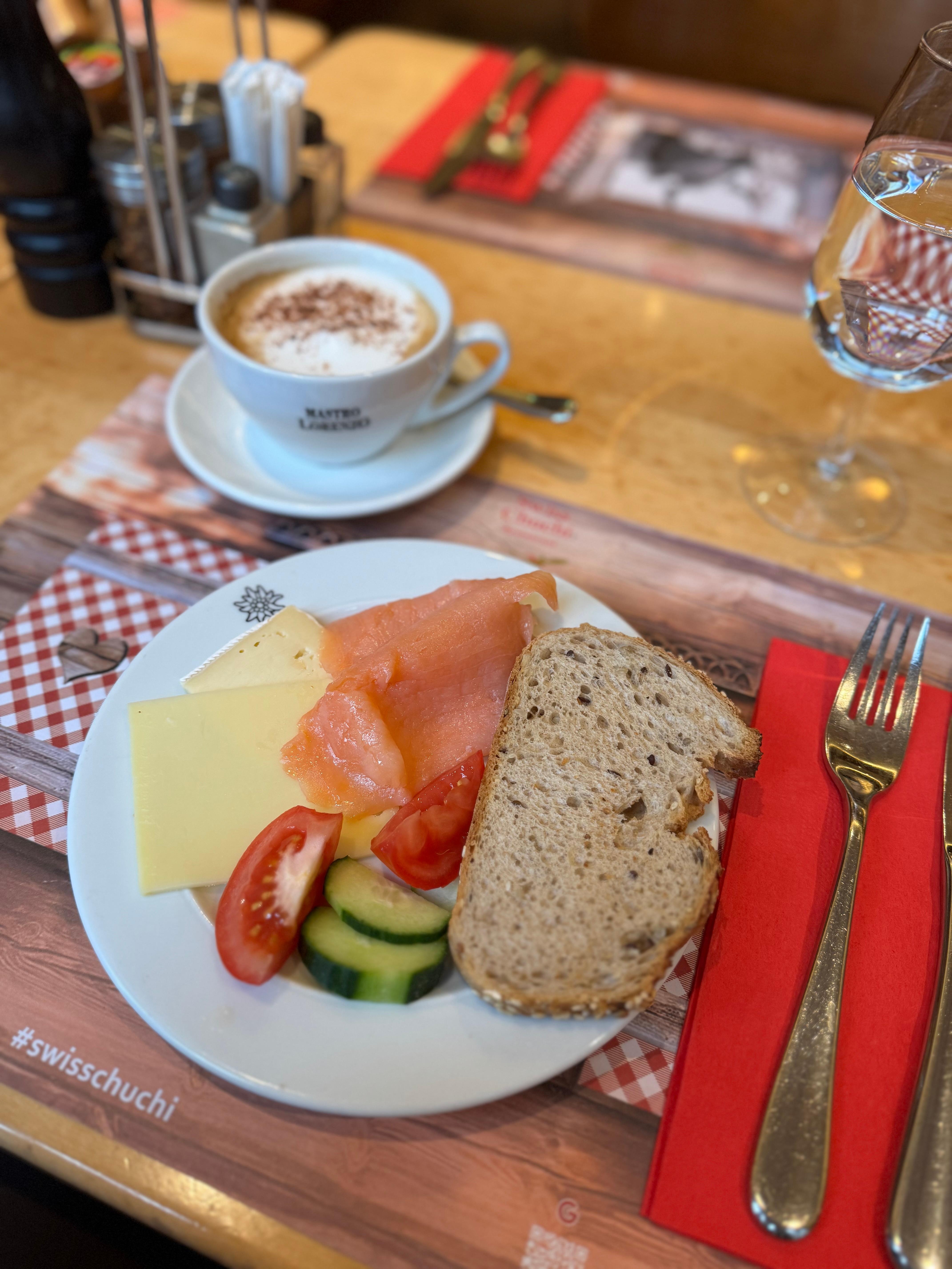 Breakfast - smoked salmon, bread options, selection of cheeses, fruits and veggies. Cappuccino