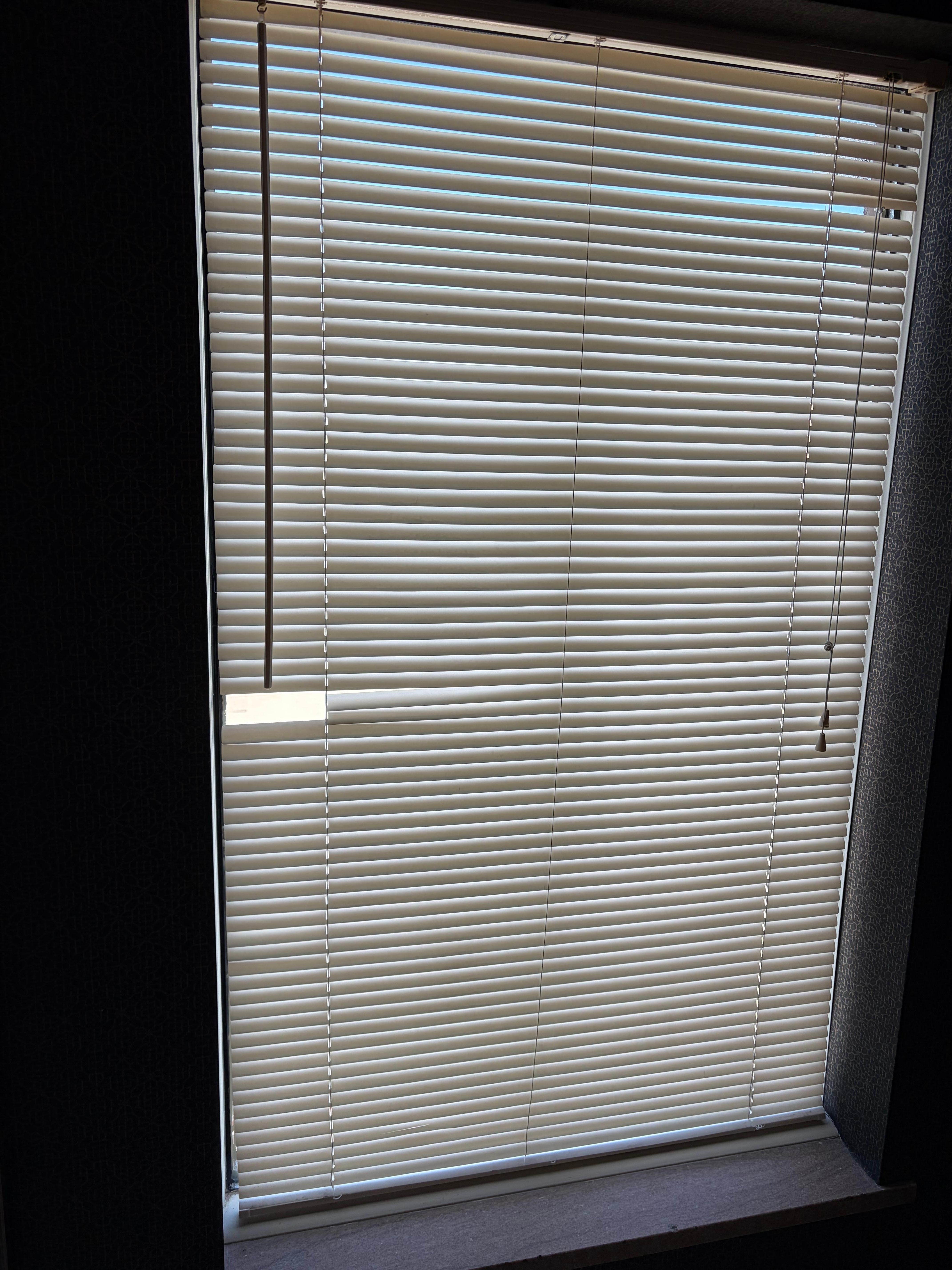 Broken and yellowed blinds in bathroom