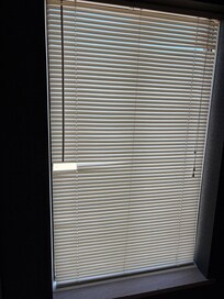 Broken and yellowed blinds in bathroom