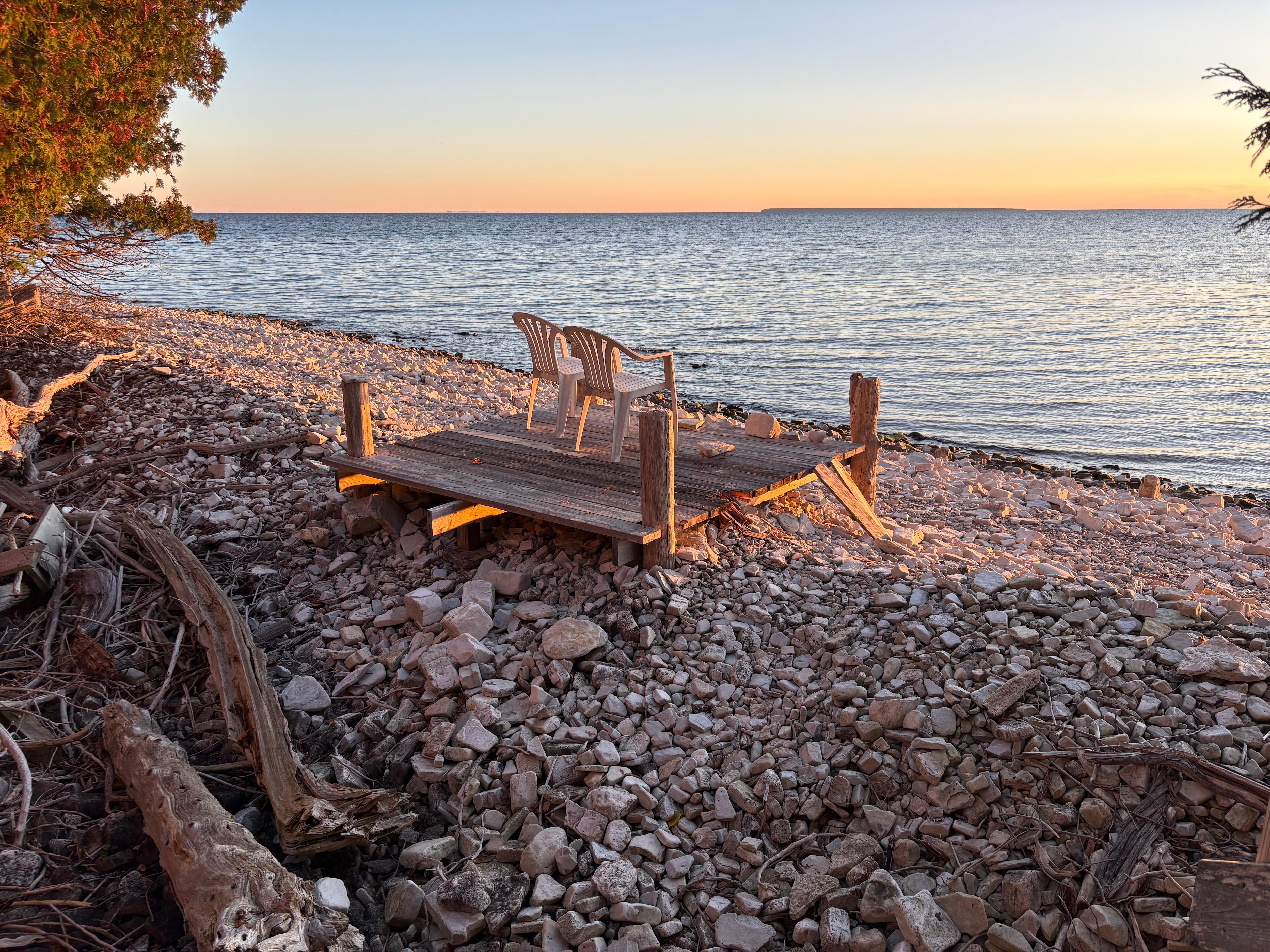 Seating lakeside at the bottom of the stairs below the house