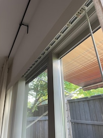 Sliding glass door missing more than half its blinds (which were found broken in one of the bedroom closets)