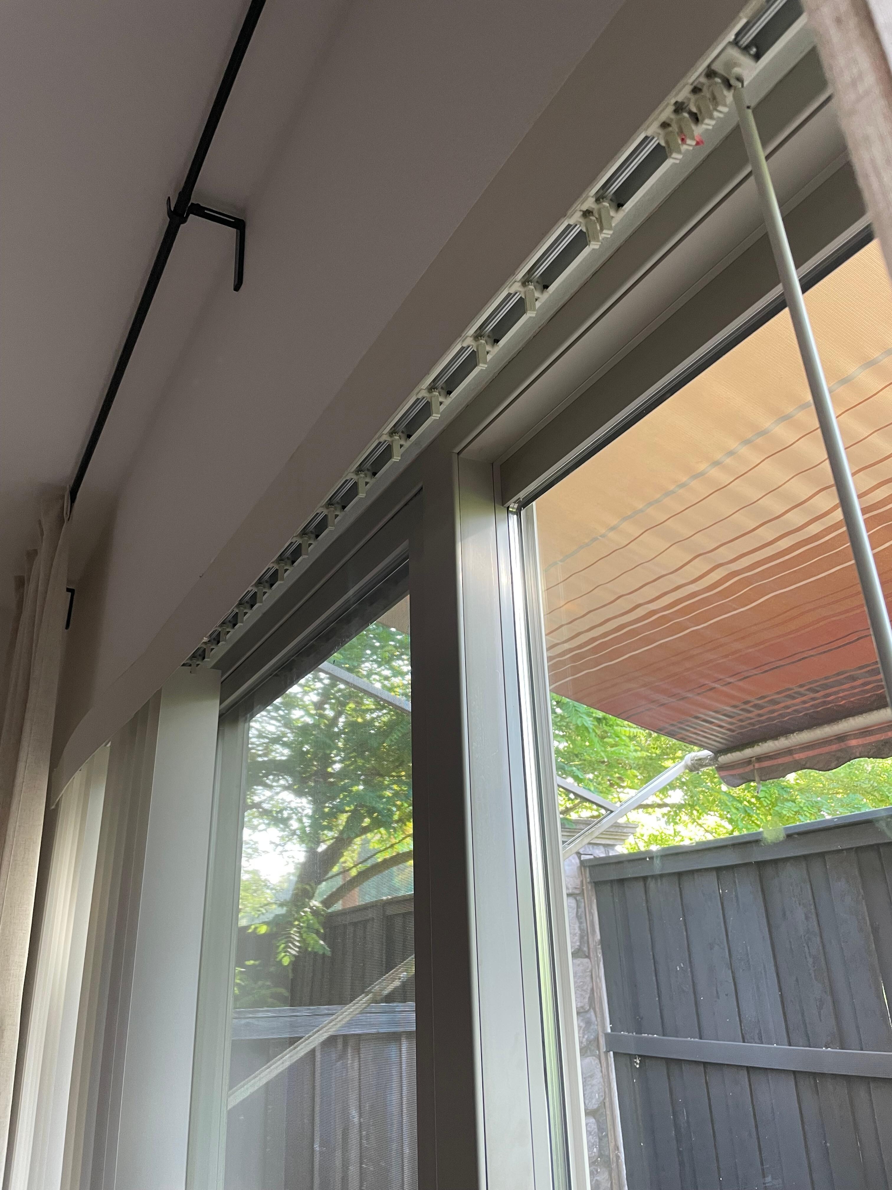 Sliding glass door missing more than half its blinds (which were found broken in one of the bedroom closets)