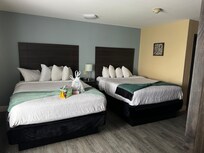 The bedroom area with double queen beds. The bed covers and pillowcases were stained/dirty. Front desk said it was a bleach stain and just stains they couldnât get rid of. I replaced the pillowcases just in case.