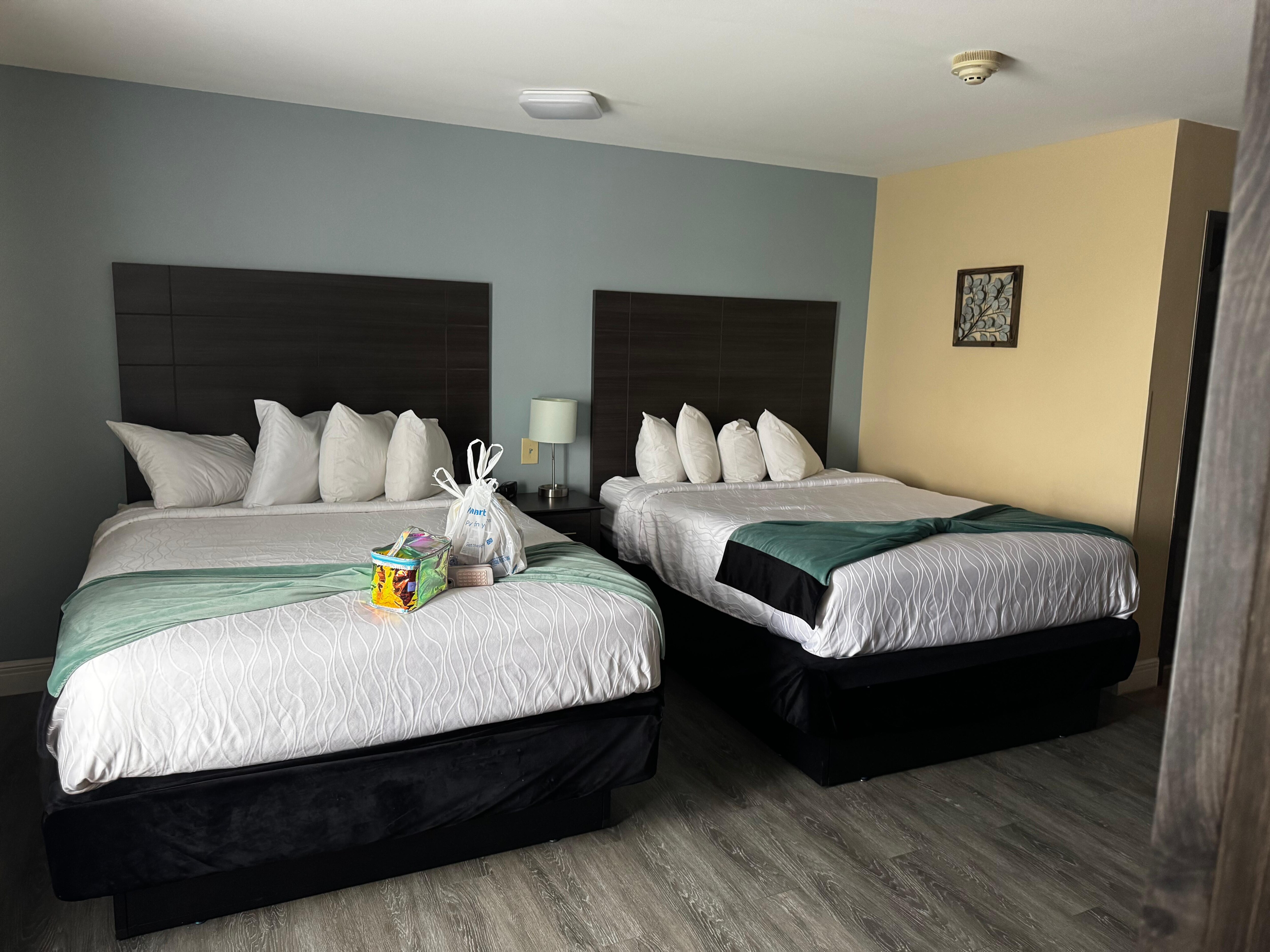 The bedroom area with double queen beds. The bed covers and pillowcases were stained/dirty. Front desk said it was a bleach stain and just stains they couldn’t get rid of. I replaced the pillowcases just in case. 