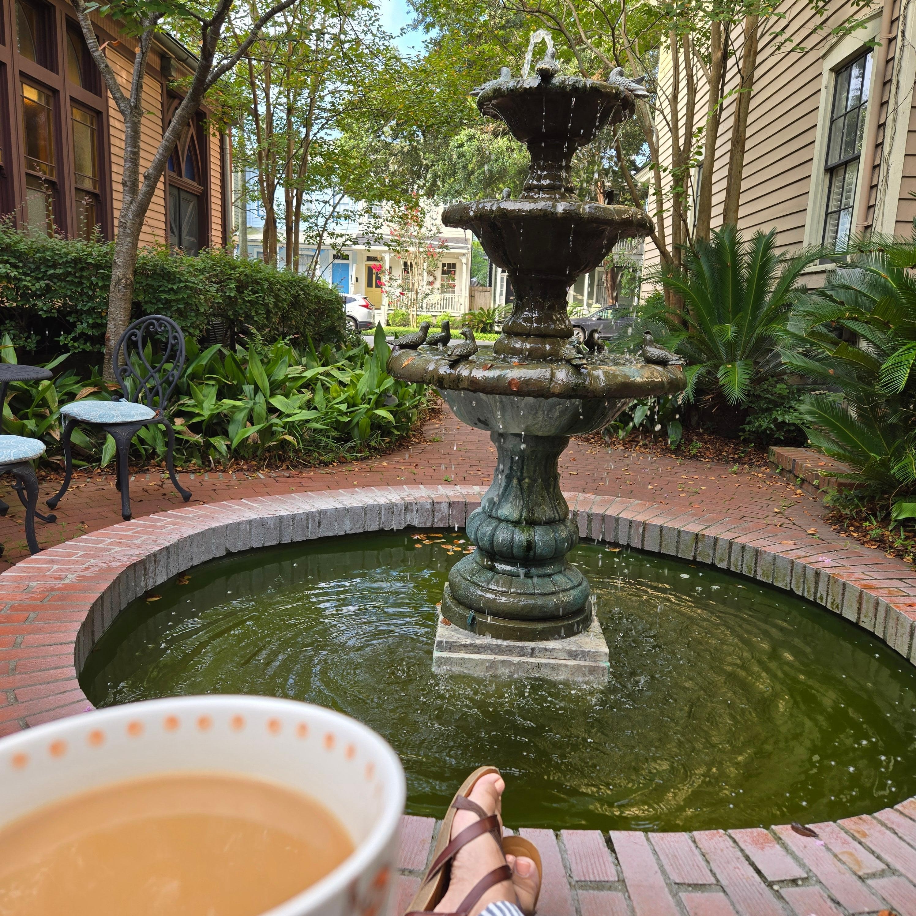 Enjoying a cup of coffee by the fountain on the patio!