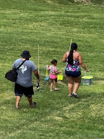 Picture taken from balcony, family on their way to fish.