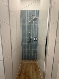 Shower stall is so narrow that hard to get in with the door that goes inward and plumbing was leaky