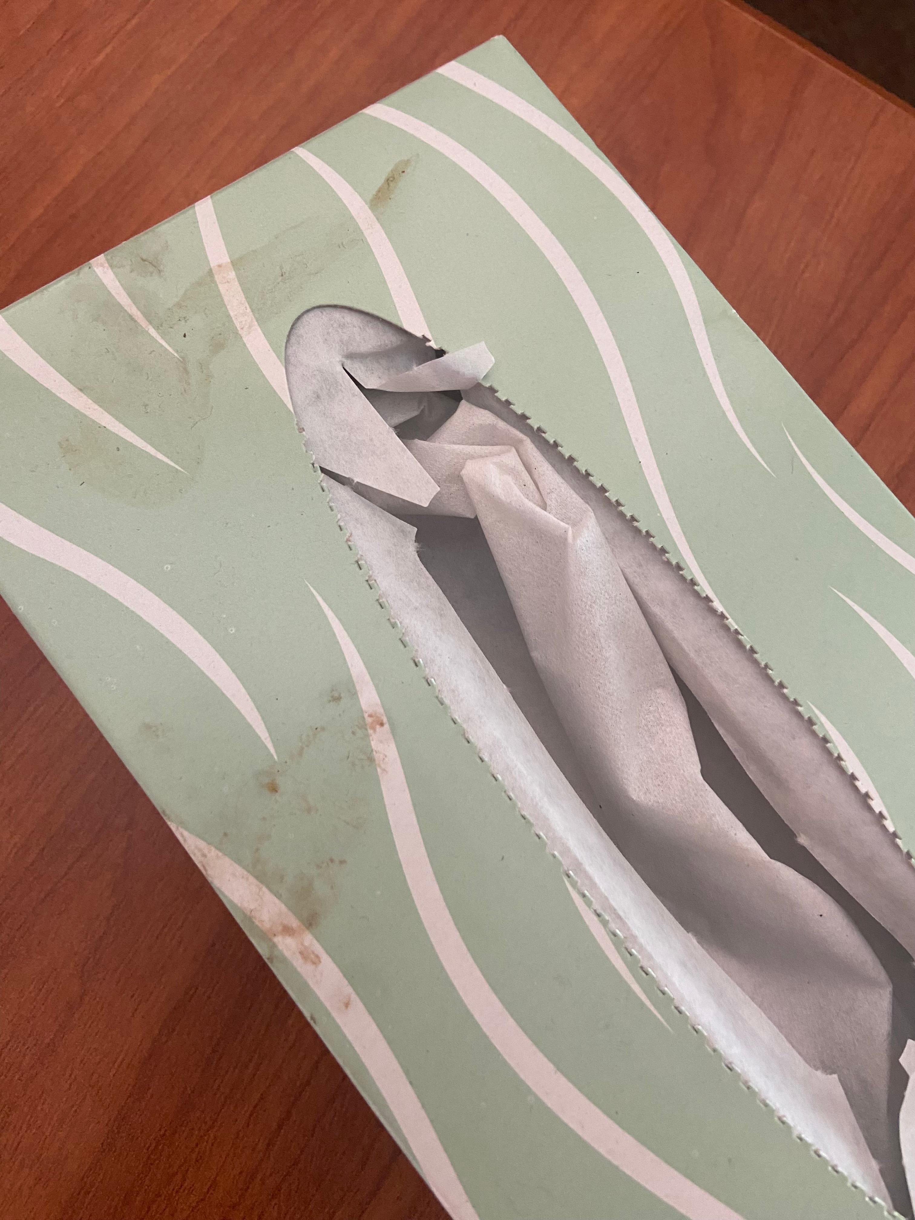 Dirty used tissue box on coffee table 