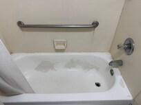 This is the tub. Peeling and black around edges in places.water pressure was fine.