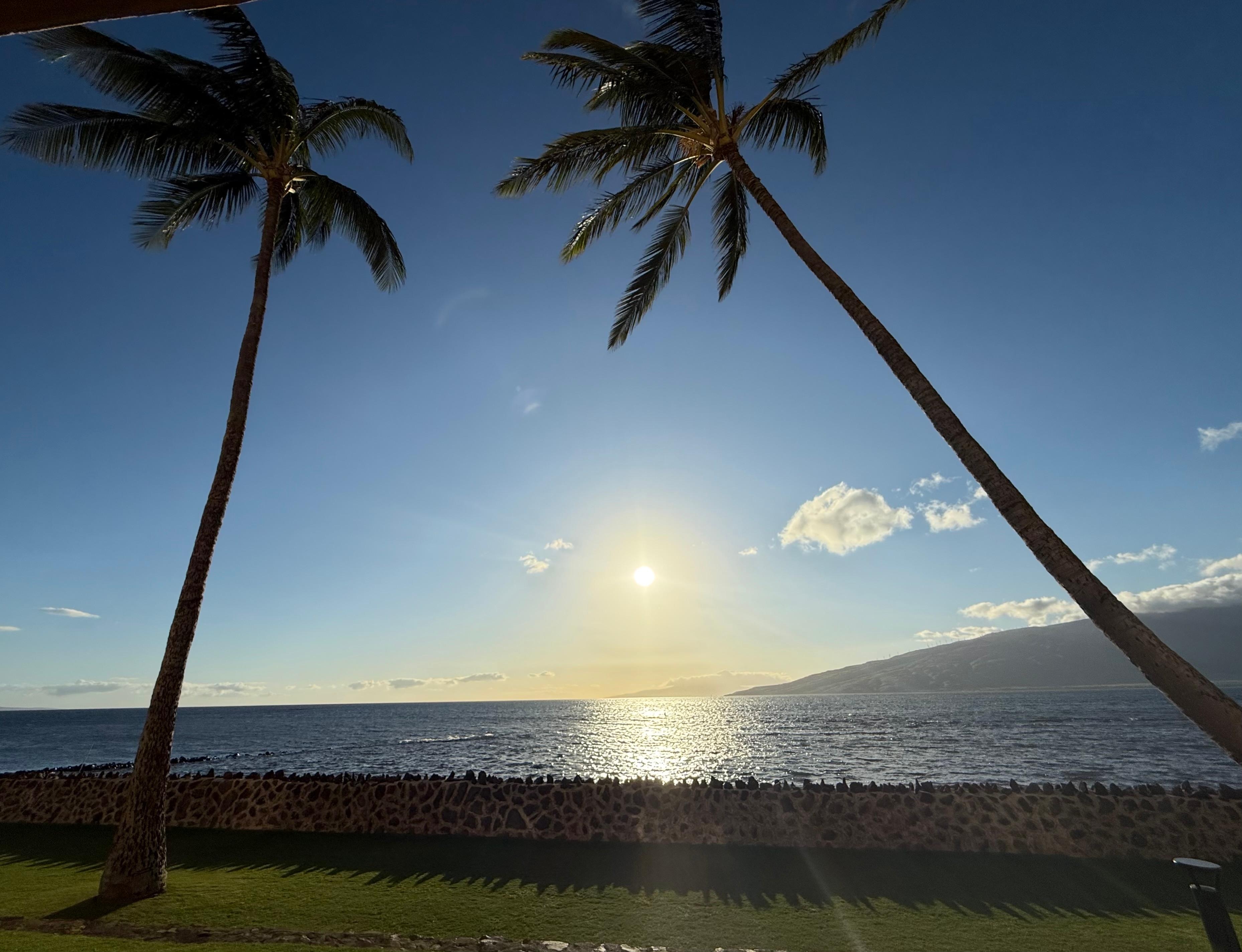 View from our lanai of the sun setting low in the western sky.