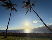 View from our lanai of the sun setting low in the western sky.