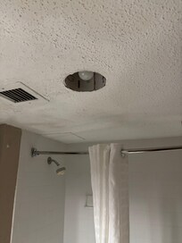 Parts of light missing. Cracks in ceiling and poorly repaired.