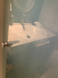 Dirty glass door to bathroom, hadn’t been cleaned in a while.