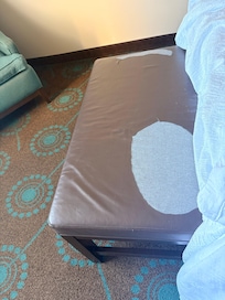 Ottoman at the foot of the bed. Get rid of it!