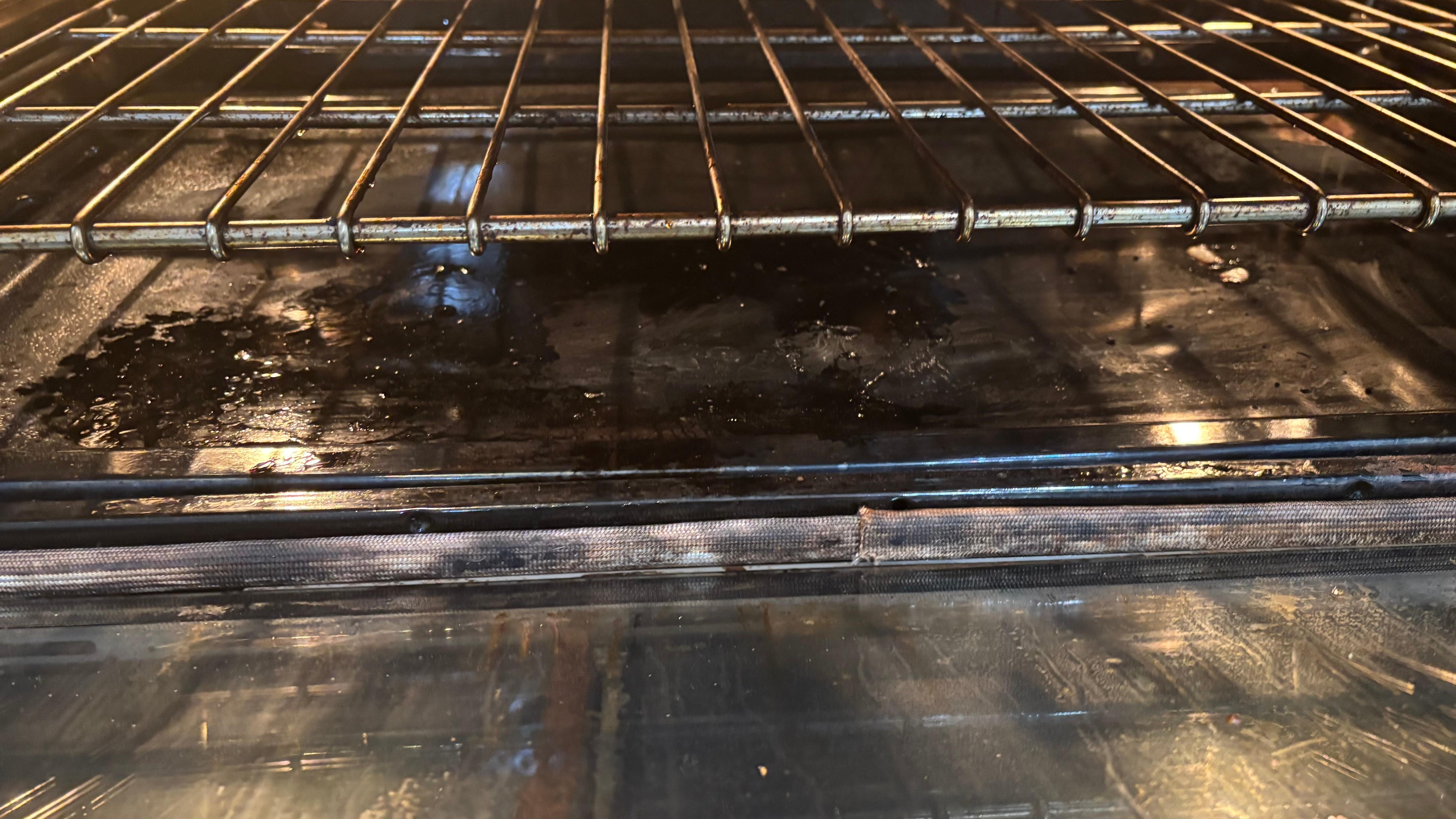 When we turned on the oven to preheat it, the entire house filled with smoke. When we opened the oven, we found what looked like canceled that was never wiped out.