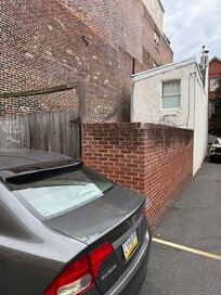 Paid parking is available behind the house. Brick walled in courtyard off from the kitchen.