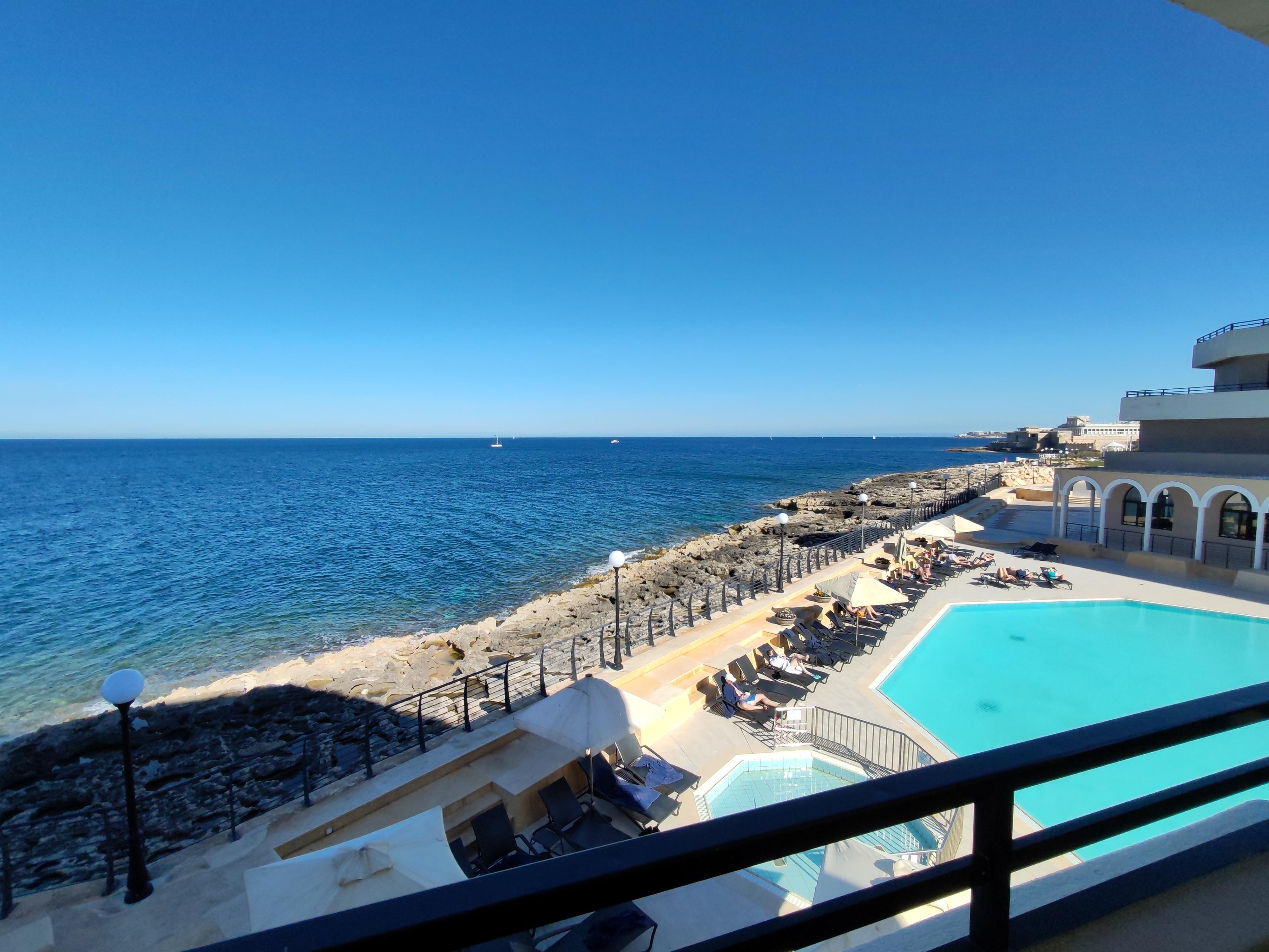 View of outdoor pool and sea from the balcony 
