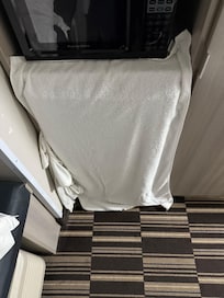 Holes in wall behind microwave and fridge!!!