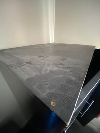 Piles of dust on cabinets, drawers, and desk.