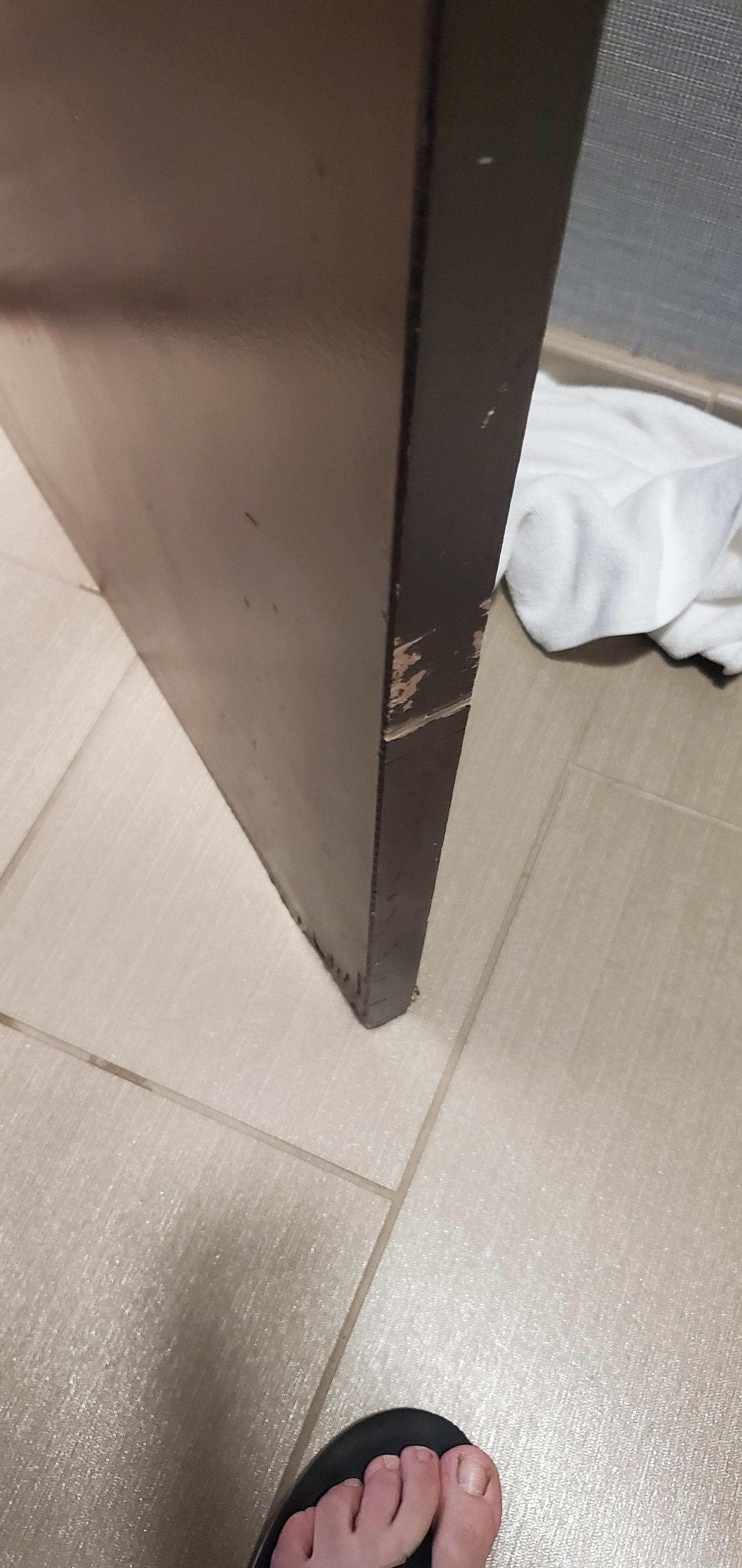 Door hits the toilet. Damage is evident