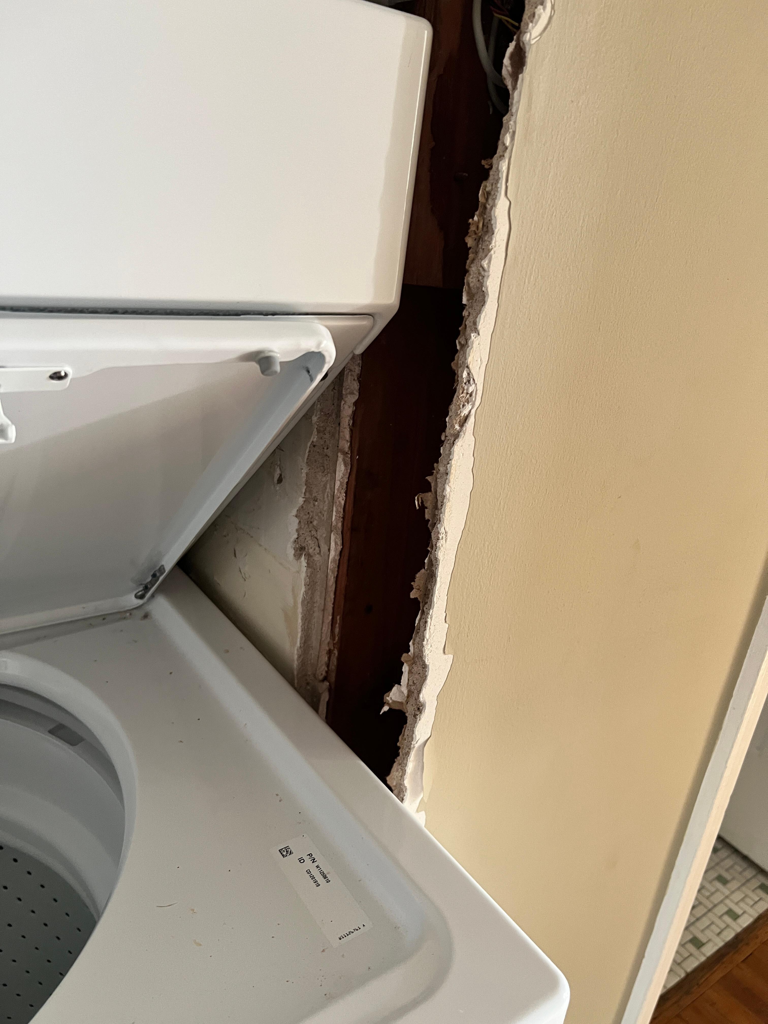 Bare wall around washer dryer.
