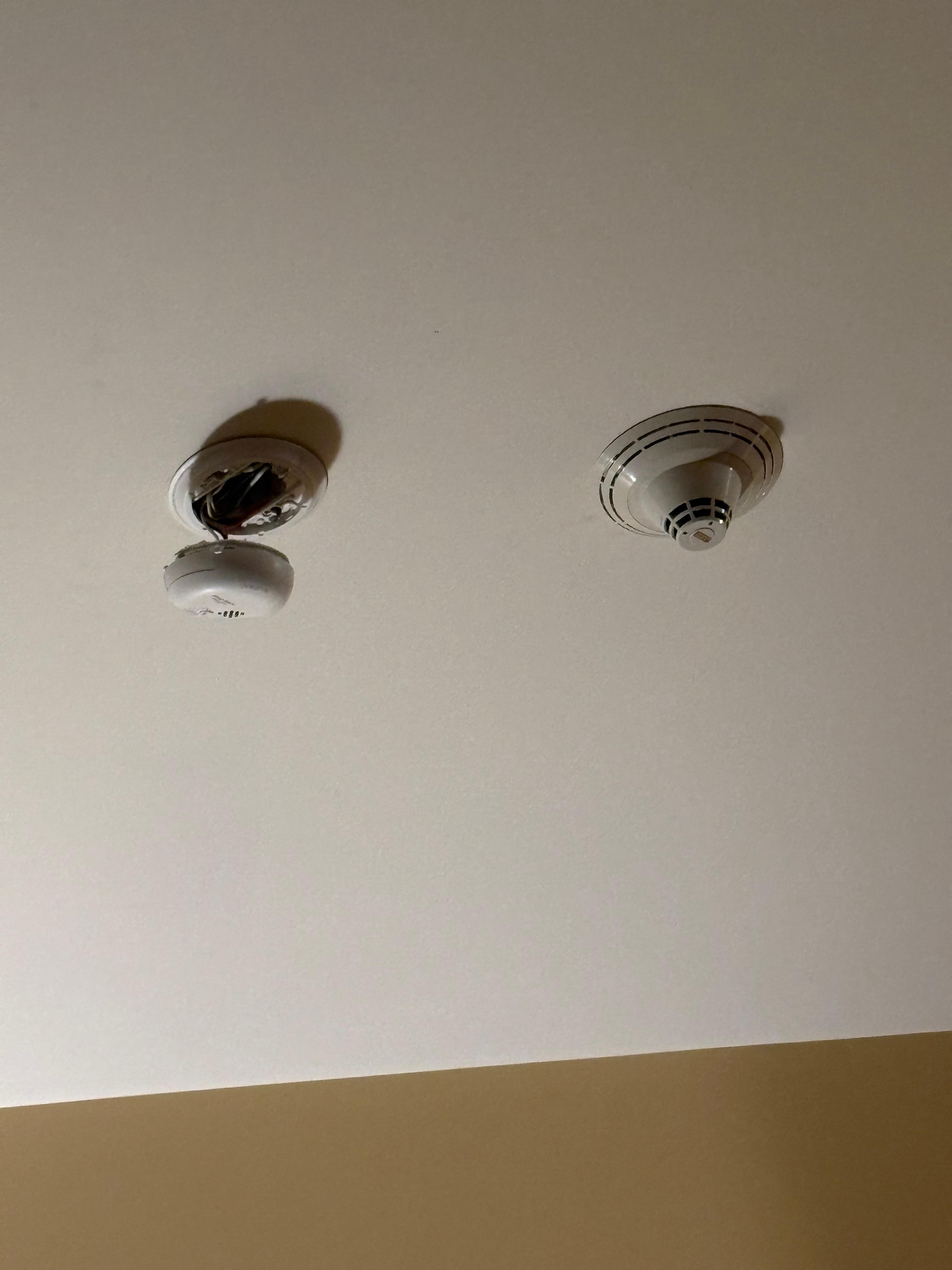 Fire alarm dangling from ceiling 