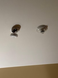 Fire alarm dangling from ceiling