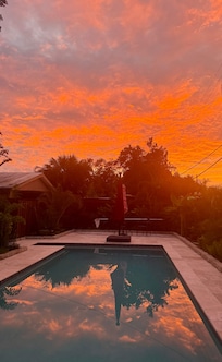 Comfy chairs, sparkling pool, and stunning sunset!
