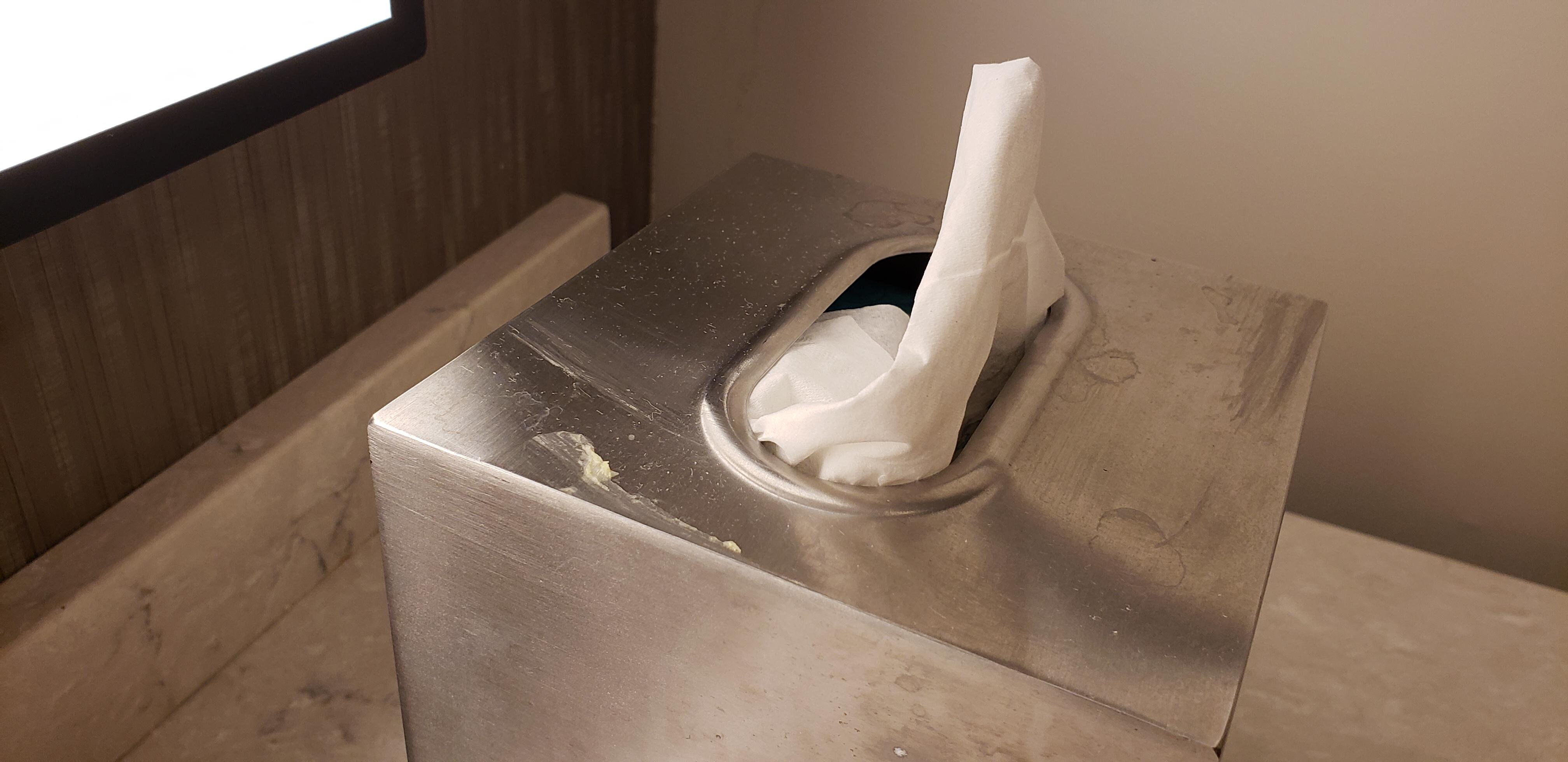 Top of tissue box, stuffed with one tissue.