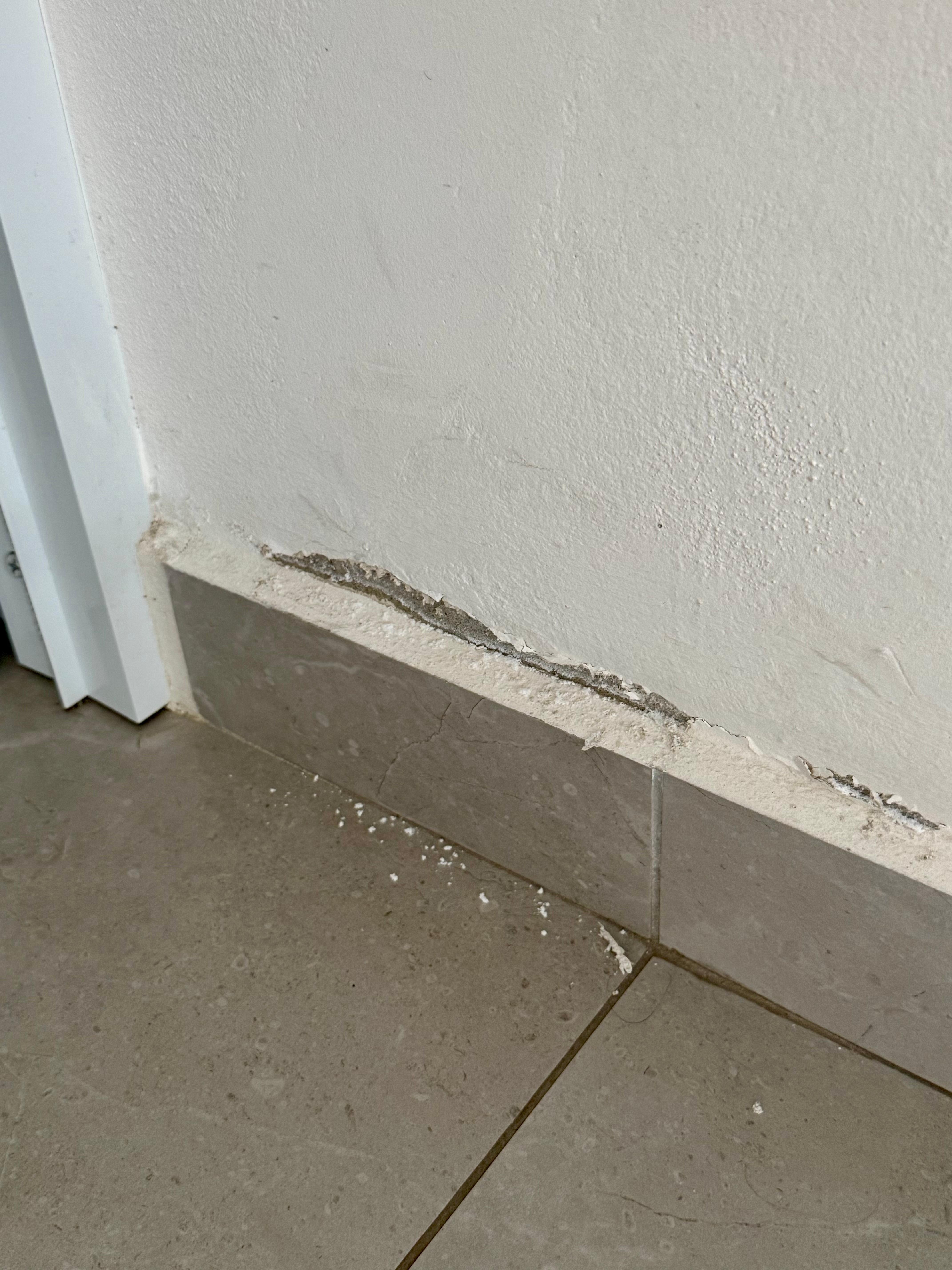 bedroom wall crumbling.
