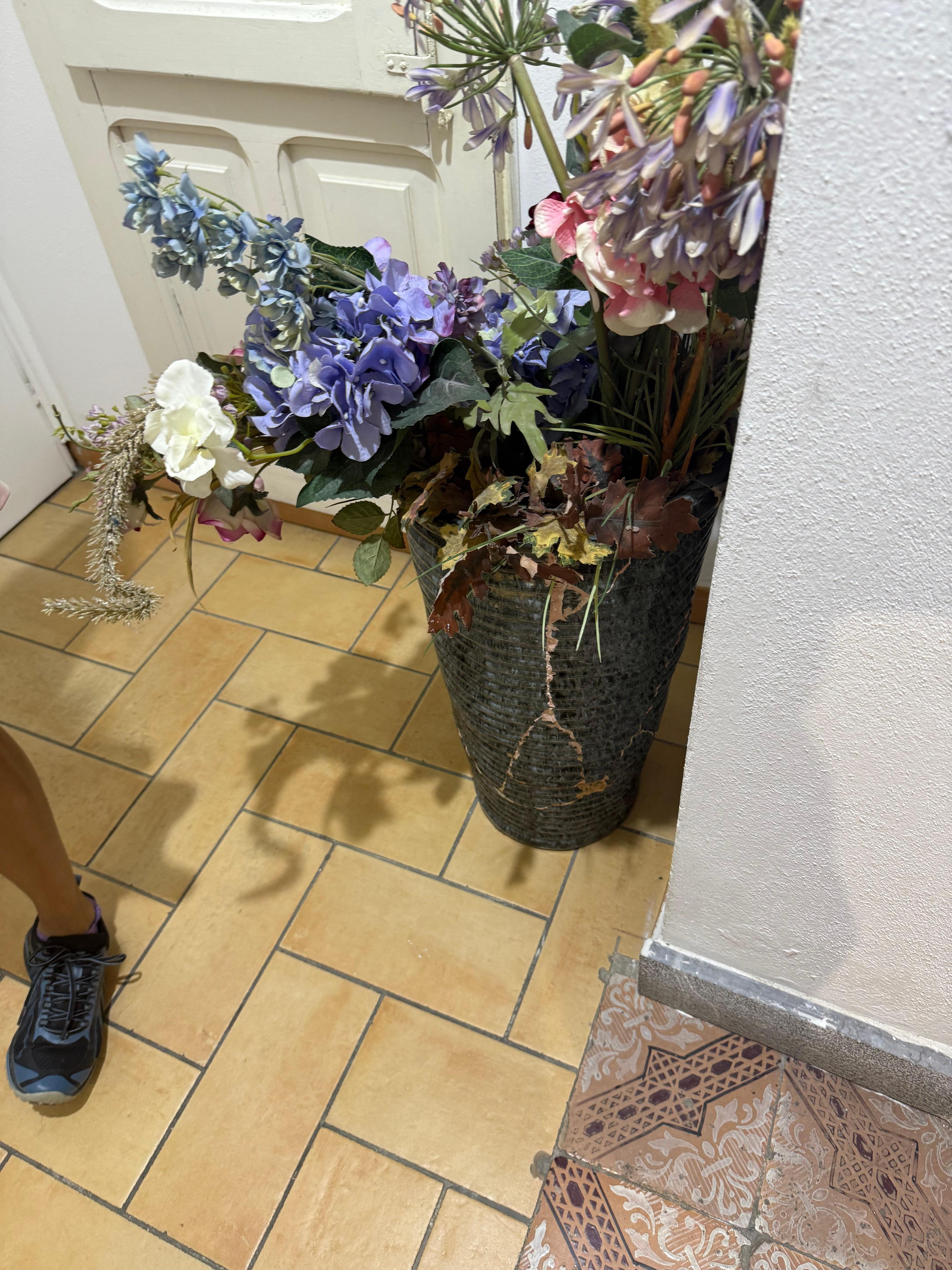 Cracked and glued flower pot in hall