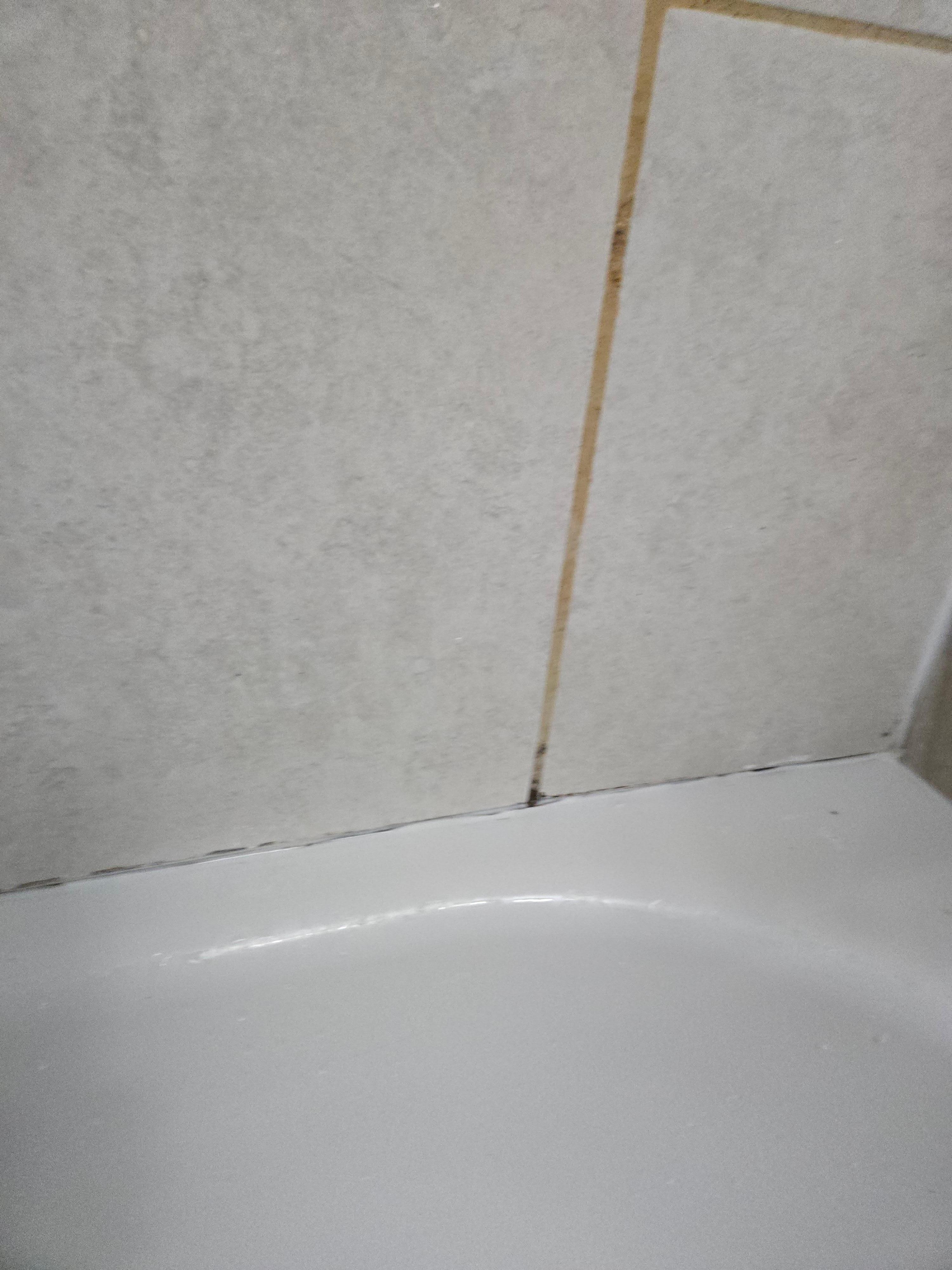 Black would along edge of tub tiles