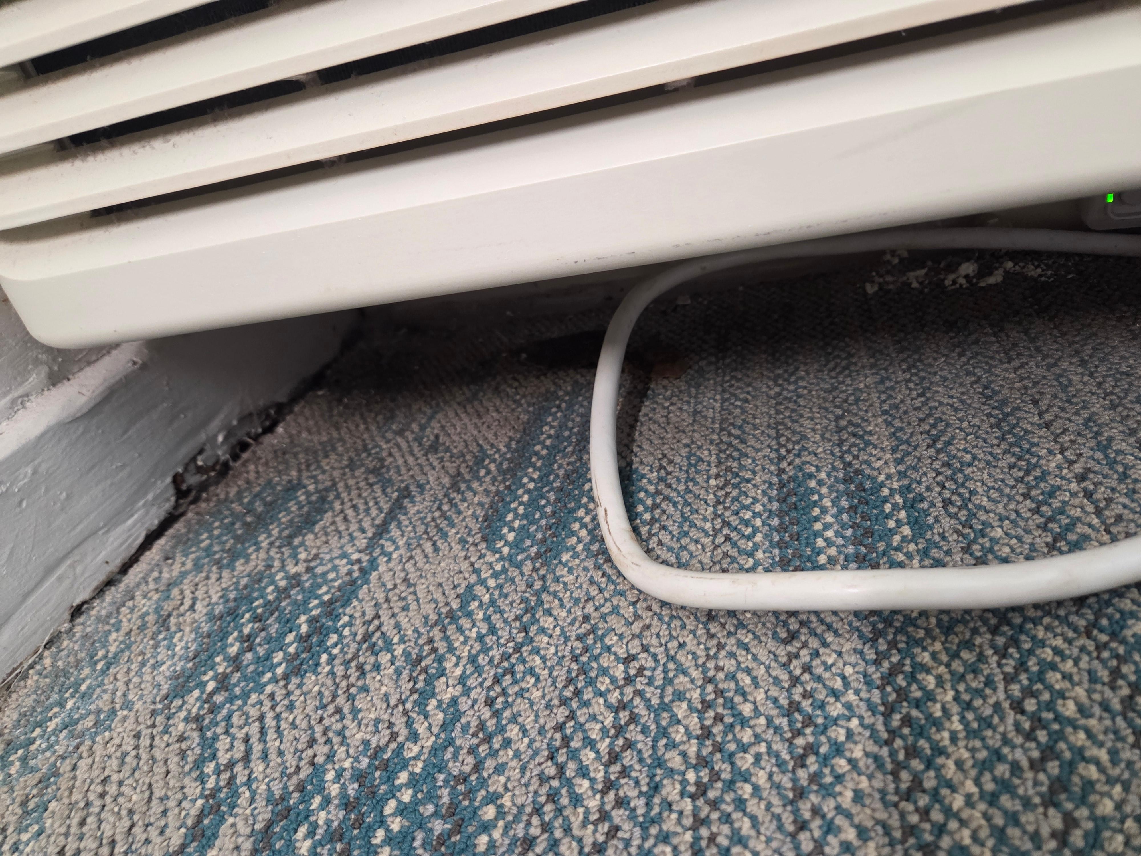 Underneath the AC unit.