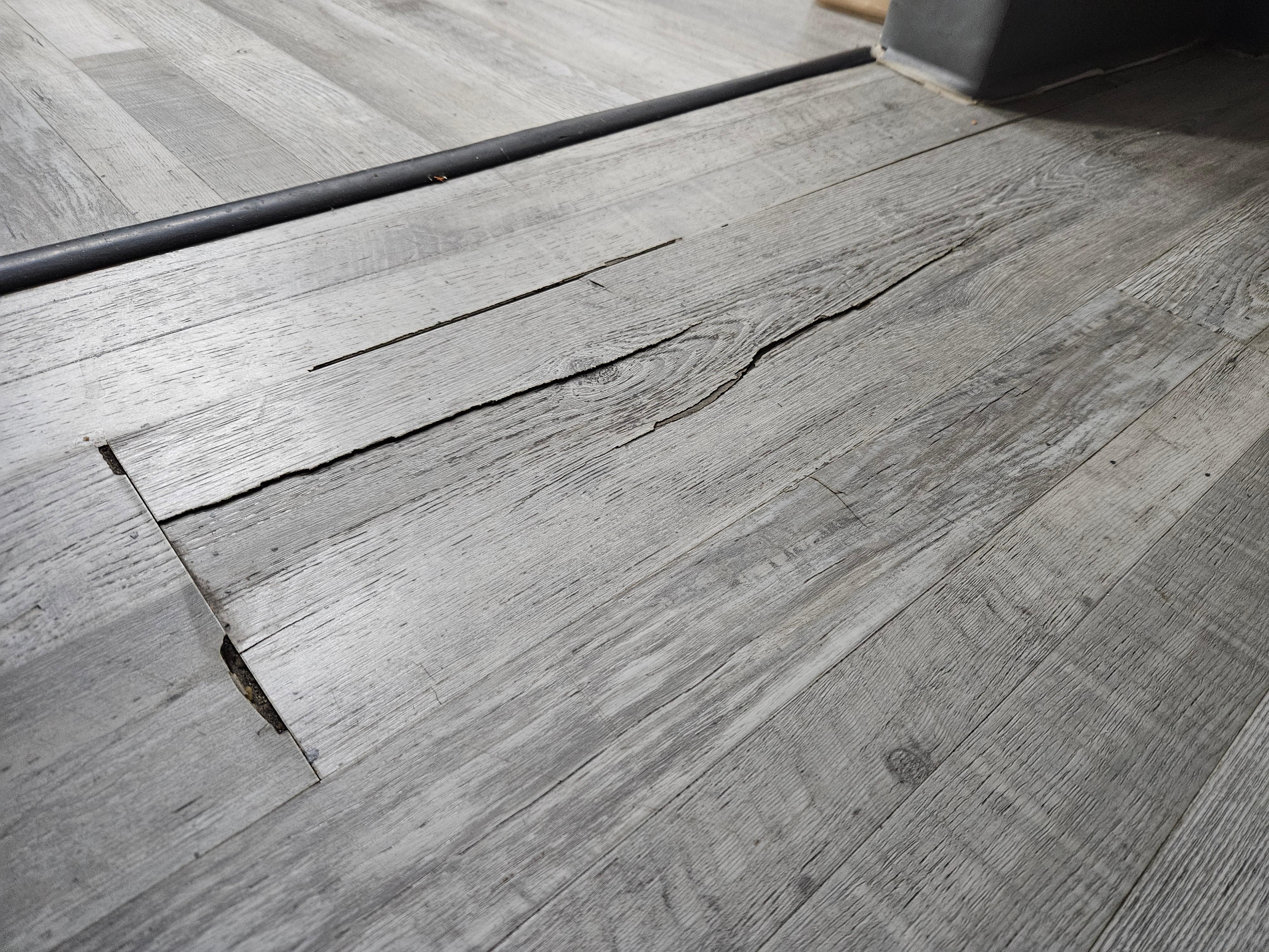 Cracked flooring and trip hazard. It bent when we walked on it.