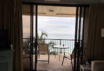 View from kitchen looking out to balcony w/double screens and slider doors open