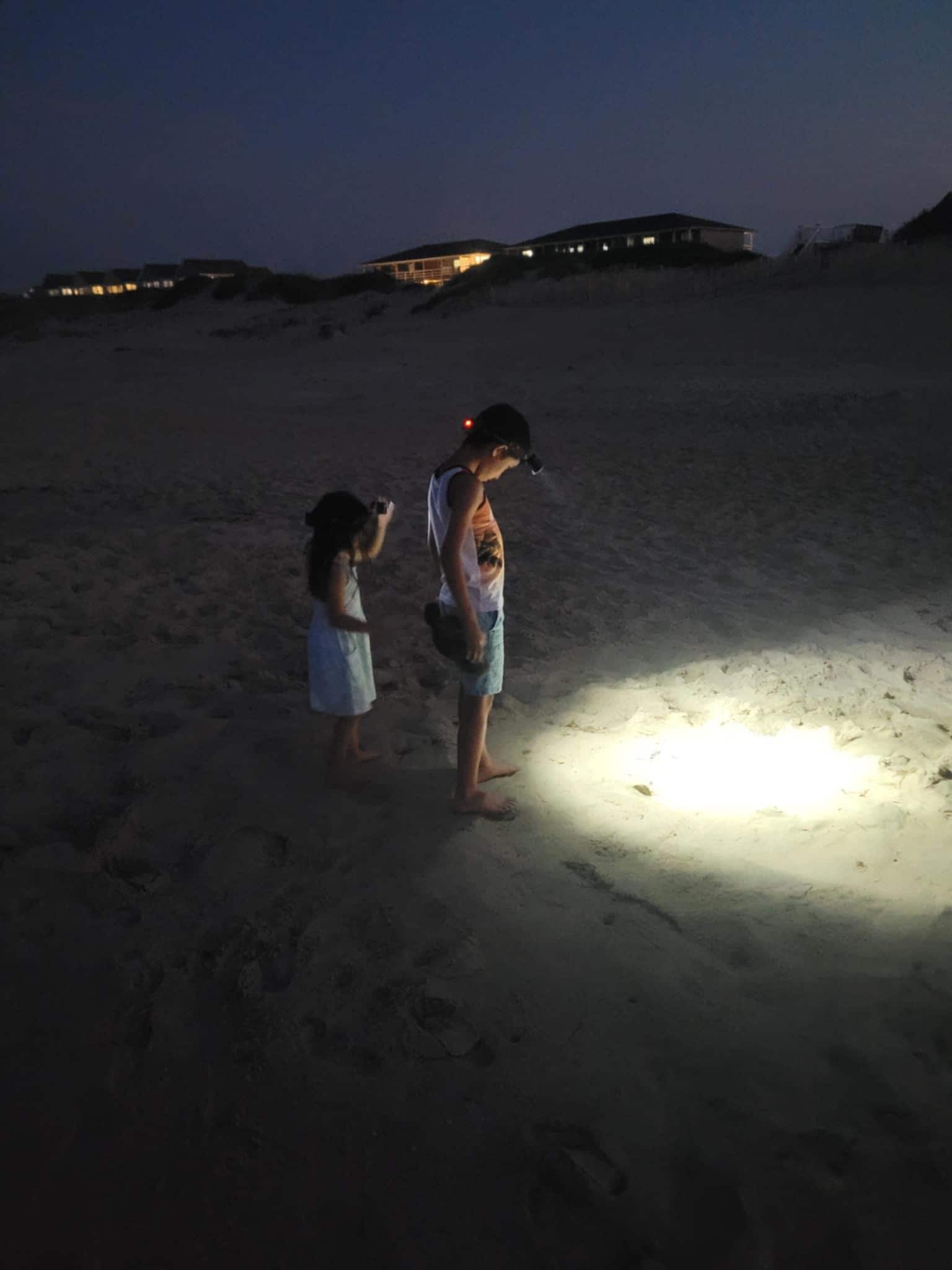 Kids walking the beach with headlamps!