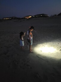 Kids walking the beach with headlamps!